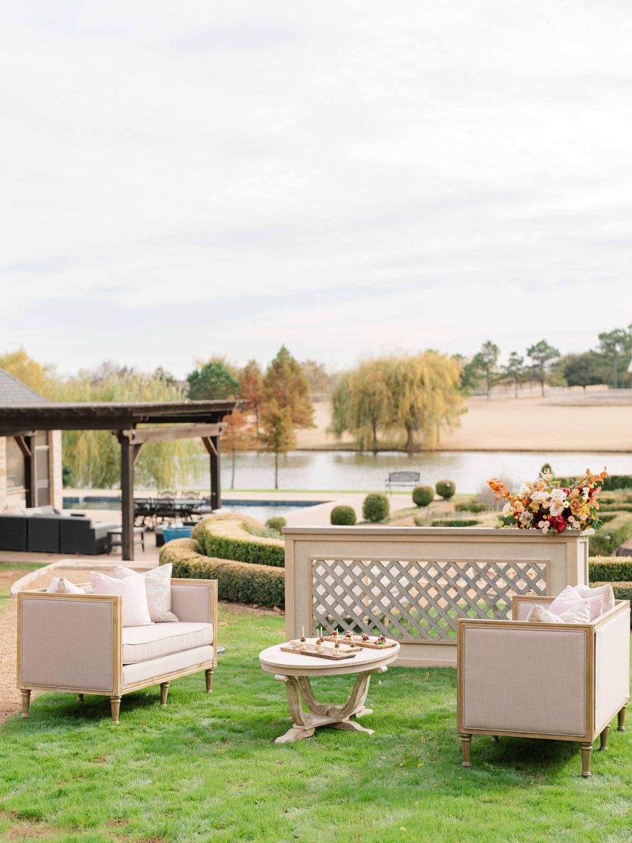 Lounge chairs on the lawn by the lake at The Bower